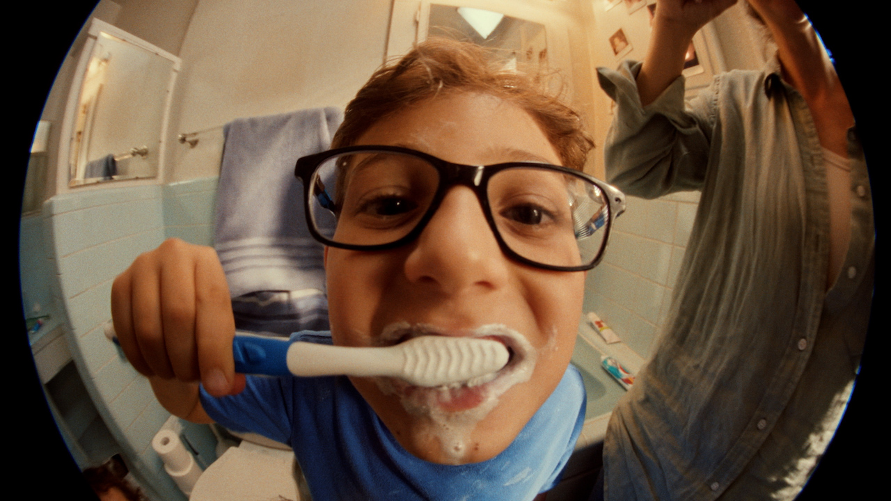 A boy brushing his teeth.